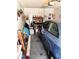 A garage with a blue compact car parked inside and a work bench along the back wall at 8810 41St N St, Pinellas Park, FL 33782
