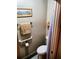 Toilet room showing a toilet with supportive railings and a wall painting above the toilet at 8810 41St N St, Pinellas Park, FL 33782