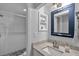 Updated bathroom featuring stylish vanity, framed mirror, and tiled walk-in shower at 337 Rex Pl # E, Madeira Beach, FL 33708
