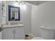 Bathroom features a granite countertop, white vanity, and modern fixtures at 337 Rex Pl # E, Madeira Beach, FL 33708