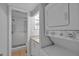 Modern bathroom with a shower and in-unit laundry, maximizing space and convenience at 337 Rex Pl # E, Madeira Beach, FL 33708