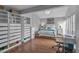 Bright bedroom with a bed, vaulted ceiling, work desk, and laminate flooring at 337 Rex Pl # E, Madeira Beach, FL 33708