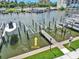 Boat slip with boat lift in canal with grassy area next to property at 337 Rex Pl # E, Madeira Beach, FL 33708