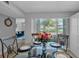 This dining room has a glass table, stylish chairs, and a scenic view at 337 Rex Pl # E, Madeira Beach, FL 33708
