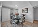 A charming dining room with a glass table, decorative chairs and tile flooring at 337 Rex Pl # E, Madeira Beach, FL 33708