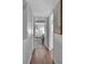 Hallway leading to the bedroom with wood laminate flooring and an art piece at 337 Rex Pl # E, Madeira Beach, FL 33708