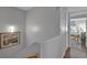 Upper landing leads to bedrooms and features an art piece on the wall at 337 Rex Pl # E, Madeira Beach, FL 33708