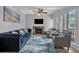 Living room with fireplace, sofa, chairs, ceiling fan, and windows at 337 Rex Pl # E, Madeira Beach, FL 33708