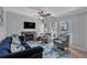 Living room with fireplace, sofa, chairs, ceiling fan, and windows at 337 Rex Pl # E, Madeira Beach, FL 33708