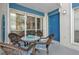 Outdoor patio with furniture, front door, surfboard, and views of the beach at 337 Rex Pl # E, Madeira Beach, FL 33708