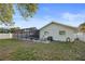 View of backyard and screened pool with patio seating, a grill, and a well-kept lawn at 10812 96Th St, Largo, FL 33773