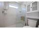 Beautiful bathroom with glass-enclosed shower and tiled walls and shower seat at 10812 96Th St, Largo, FL 33773