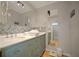 Bright bathroom with decorative tile, white countertop, and light-green vanity at 10812 96Th St, Largo, FL 33773