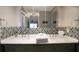 Elegant bathroom with double sinks, decorative tile backsplash, and large mirror at 10812 96Th St, Largo, FL 33773