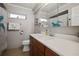 Bathroom features a modern vanity with a vessel sink, framed mirror, and turtle shower curtain at 10812 96Th St, Largo, FL 33773