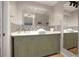 Bathroom featuring double sinks, decorative tile backsplash, and lots of storage at 10812 96Th St, Largo, FL 33773
