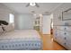 Spacious bedroom featuring hardwood floors, a ceiling fan, and a glimpse into the ensuite bathroom at 10812 96Th St, Largo, FL 33773