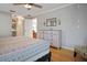 Serene bedroom showcasing hardwood floors, soft lighting, and access to the ensuite bathroom and walk-in closet at 10812 96Th St, Largo, FL 33773