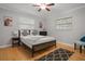 Cozy bedroom featuring a comfortable bed, wood floors, and natural light at 10812 96Th St, Largo, FL 33773