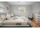 Cozy bedroom featuring a comfortable bed with floral bedding and a stylish accent chair at 10812 96Th St, Largo, FL 33773