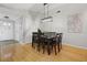 Minimalist dining area with a wooden table set for six, featuring ample natural light and a map of Florida art piece at 10812 96Th St, Largo, FL 33773
