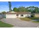 Charming single-story home with a well-maintained lawn, neutral paint, and an attached two-car garage at 10812 96Th St, Largo, FL 33773