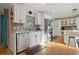 Modern kitchen with white cabinets, granite countertops, stainless steel appliances, and sleek backsplash at 10812 96Th St, Largo, FL 33773