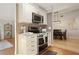 Stylish kitchen featuring stainless steel appliances, cream cabinets, a modern backsplash, and hardwood floors at 10812 96Th St, Largo, FL 33773