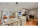 Spacious kitchen island with marble countertops and seating, seamlessly connected to the living and dining areas at 10812 96Th St, Largo, FL 33773