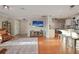 Cozy living room featuring wood floors, stylish furniture, and an open floor plan with a view into the kitchen at 10812 96Th St, Largo, FL 33773