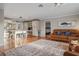 Spacious living room with wood floors, a comfortable leather sofa, and seamless access to the modern kitchen at 10812 96Th St, Largo, FL 33773