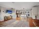 Inviting living room with hardwood floors, a mounted TV, open layout, and easy transition to the adjacent kitchen area at 10812 96Th St, Largo, FL 33773