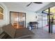 Relaxing screened patio with a lounge chair and an outdoor kitchen at 10812 96Th St, Largo, FL 33773