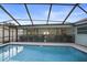 View of screened-in pool and patio with outdoor furniture and a safety fence at 10812 96Th St, Largo, FL 33773