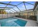 View of screened-in pool and patio with outdoor furniture and a safety fence at 10812 96Th St, Largo, FL 33773
