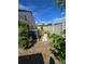 Well-maintained backyard with a vinyl fence, landscaping, and AC unit at 10825 Venice Cir, Tampa, FL 33635