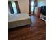 Bright bedroom with dark wood floors, two windows, and neutral decor at 10825 Venice Cir, Tampa, FL 33635