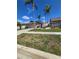 Well-maintained single-story home with an attached garage and tropical palm tree landscaping at 10825 Venice Cir, Tampa, FL 33635