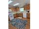 Functional kitchen with white appliances, light countertops, and abundant wood cabinetry at 10825 Venice Cir, Tampa, FL 33635