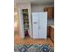Bright kitchen featuring a pantry, white refrigerator, and wood cabinets at 10825 Venice Cir, Tampa, FL 33635