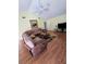 Cozy living room featuring a large sectional sofa, ceiling fan, and warm wood flooring at 10825 Venice Cir, Tampa, FL 33635