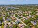 Neighborhood aerial shot showing homes surrounded by lush trees, providing a serene living environment at 1211 Penny Ct, Dunedin, FL 34698