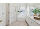 Bright bathroom featuring a jetted tub, walk-in shower, and a vanity with a sink at 1211 Penny Ct, Dunedin, FL 34698