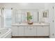 Bathroom with double sink vanity, soaking tub, and separate shower at 1211 Penny Ct, Dunedin, FL 34698