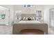 Comfortable bedroom with natural light, neutral tones, and a decorative bench at 1211 Penny Ct, Dunedin, FL 34698
