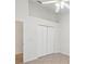 Bedroom featuring a large closet, neutral tile floors, and bright paint at 1211 Penny Ct, Dunedin, FL 34698
