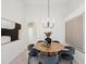 A modern dining room features a round table, gray chairs, and abstract artwork at 1211 Penny Ct, Dunedin, FL 34698