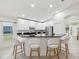 Bright kitchen with breakfast bar, white cabinets, stainless appliances, and pendant lighting at 1211 Penny Ct, Dunedin, FL 34698