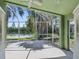 Screened lanai overlooking a tranquil pond providing an idyllic outdoor retreat at 1211 Penny Ct, Dunedin, FL 34698