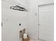 Laundry area equipped with overhead shelving, hamper and utility connections at 1211 Penny Ct, Dunedin, FL 34698
